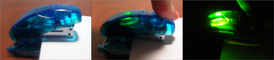 A photograph showing the LED Stapler (with paper) off, on, and on in the dark.